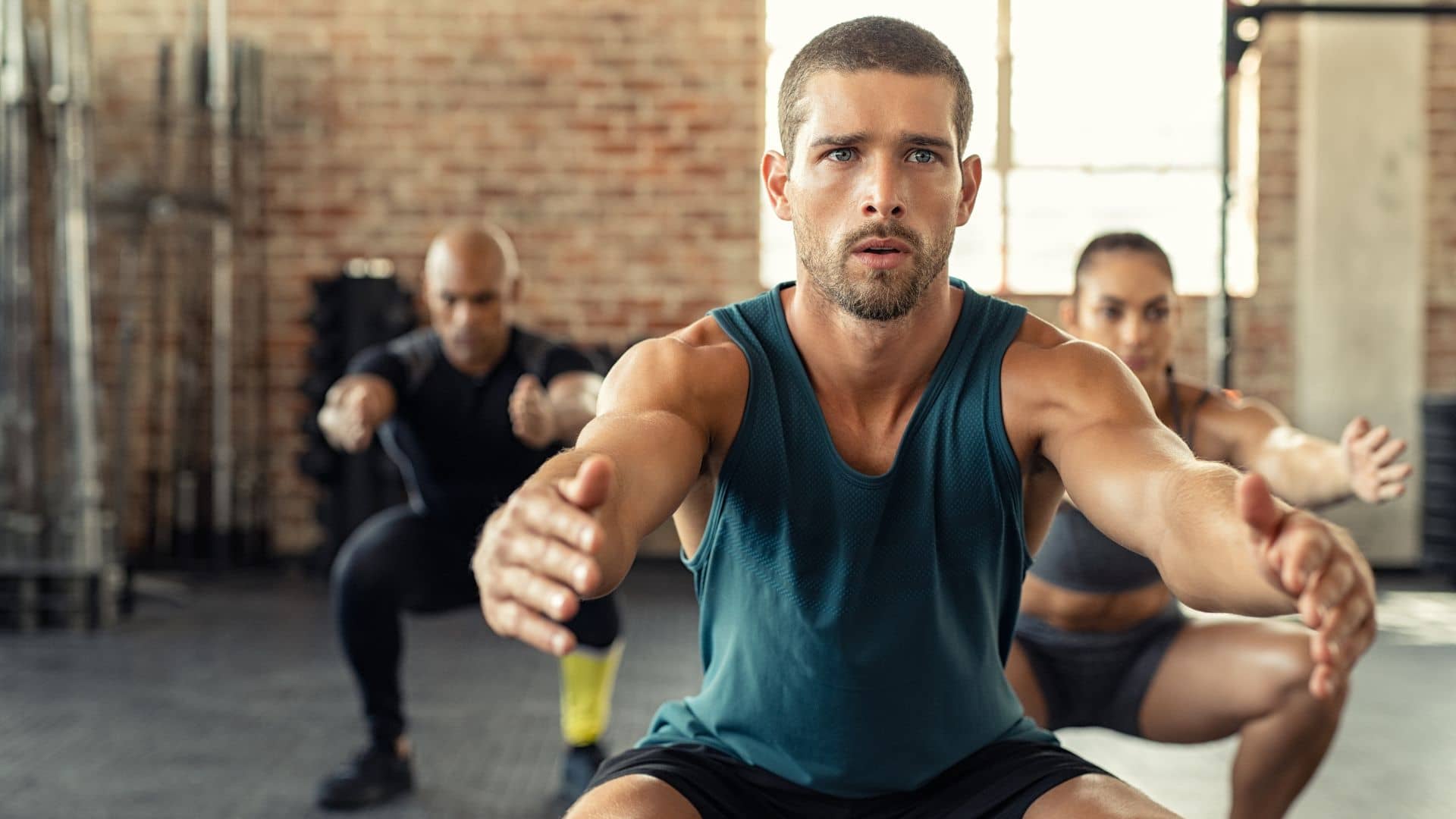 Man Squatting with a Class at the Gym