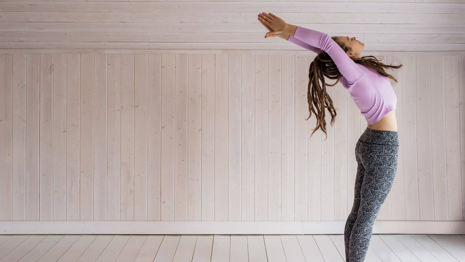 Woman In Pink Long Sleeves Top And Gray Leggings Doing Yoga