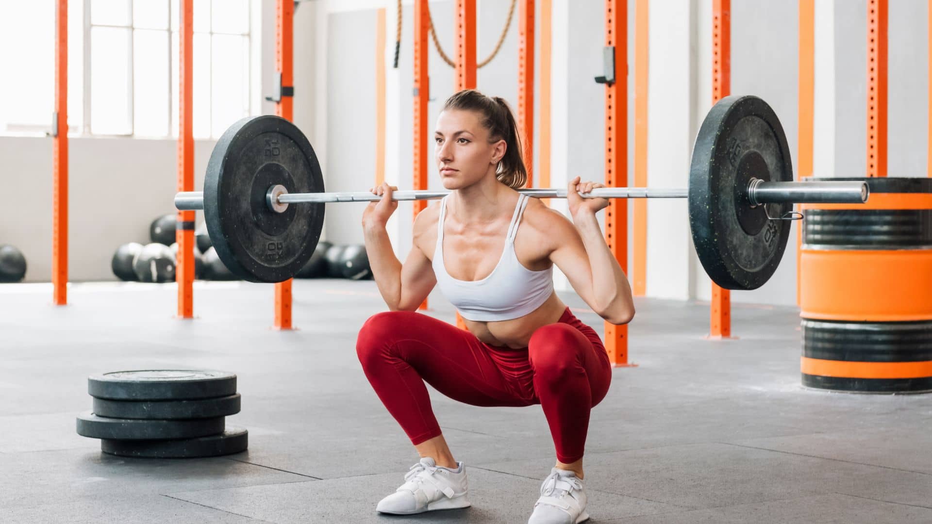 Sportswoman doing barbell back squat