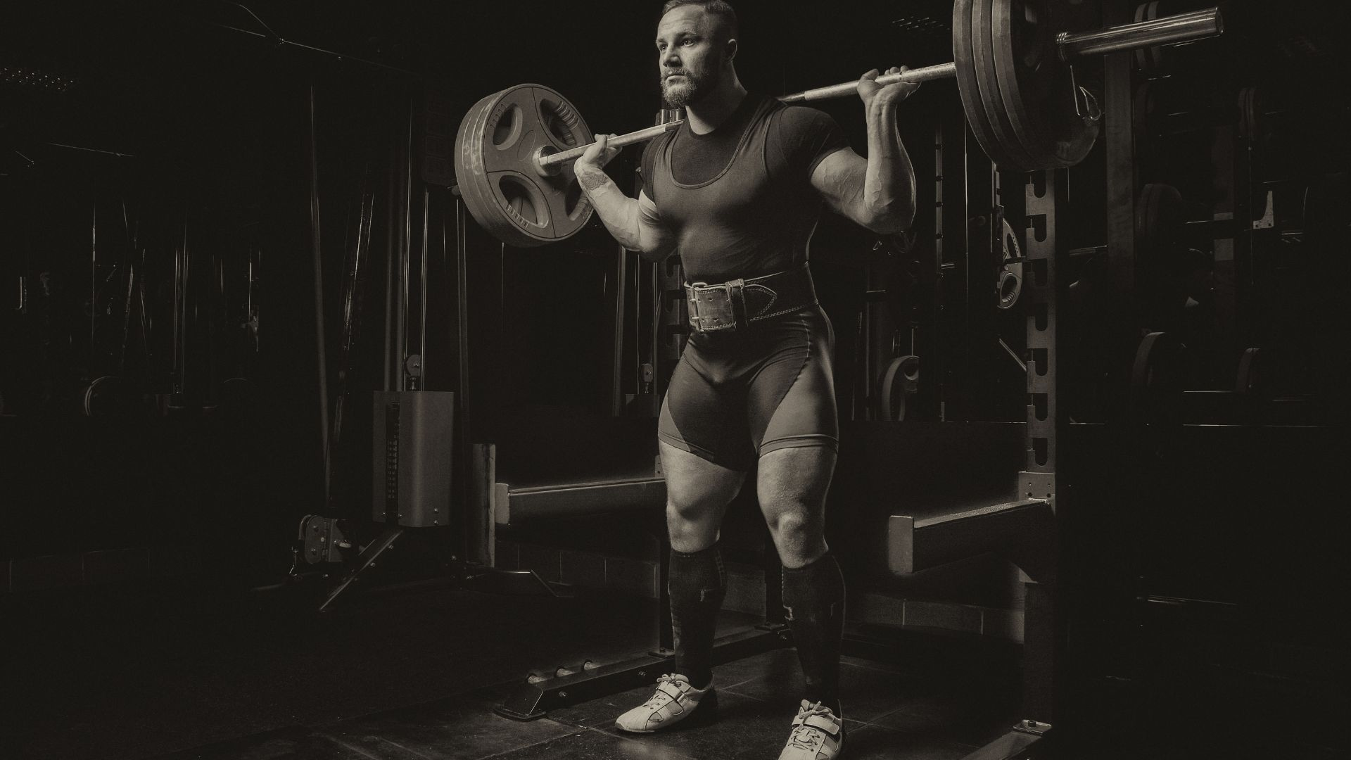 Professional athlete makes squats with a bar