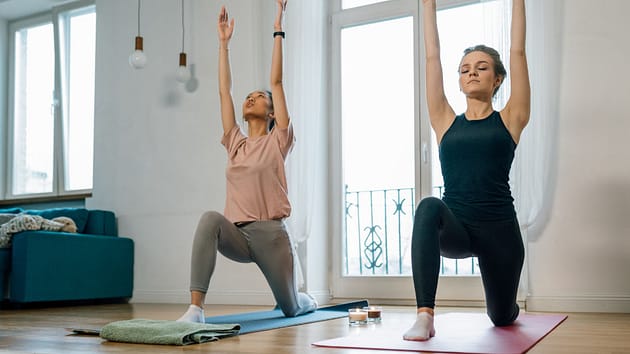 Women Doing Yoga Near Glass Door