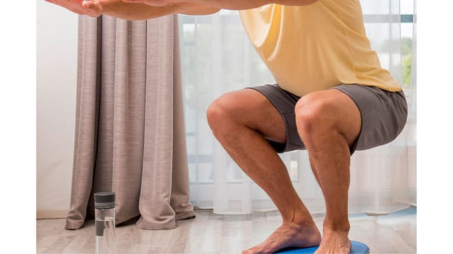 side-view-man-training-home-using-bosu-ball.jp