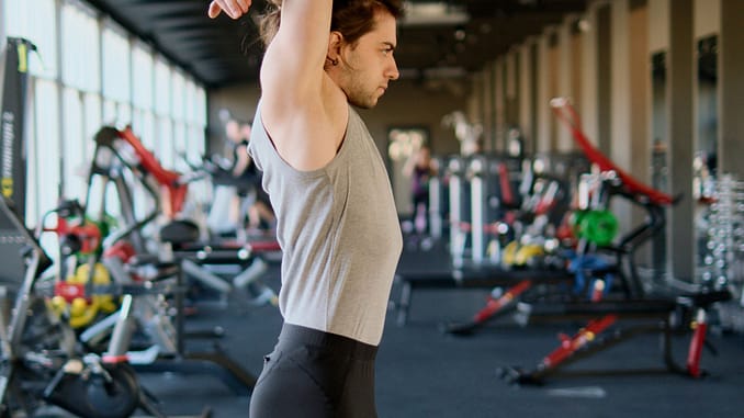 Man Stretching at a Gym