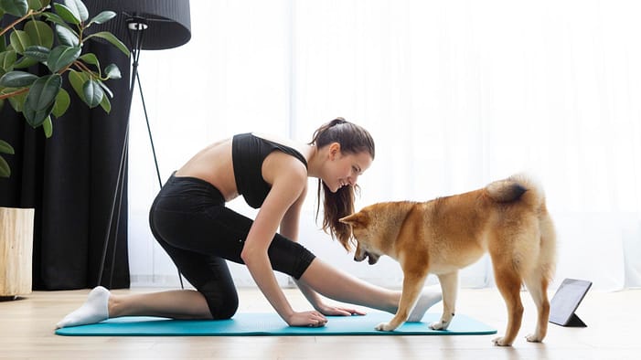 young-woman-doing-yoga-her-dog.j