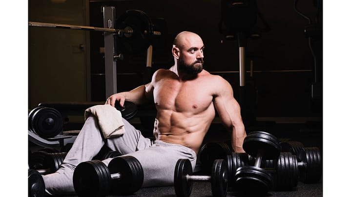 muscular-man-amidst-dumbbells.j