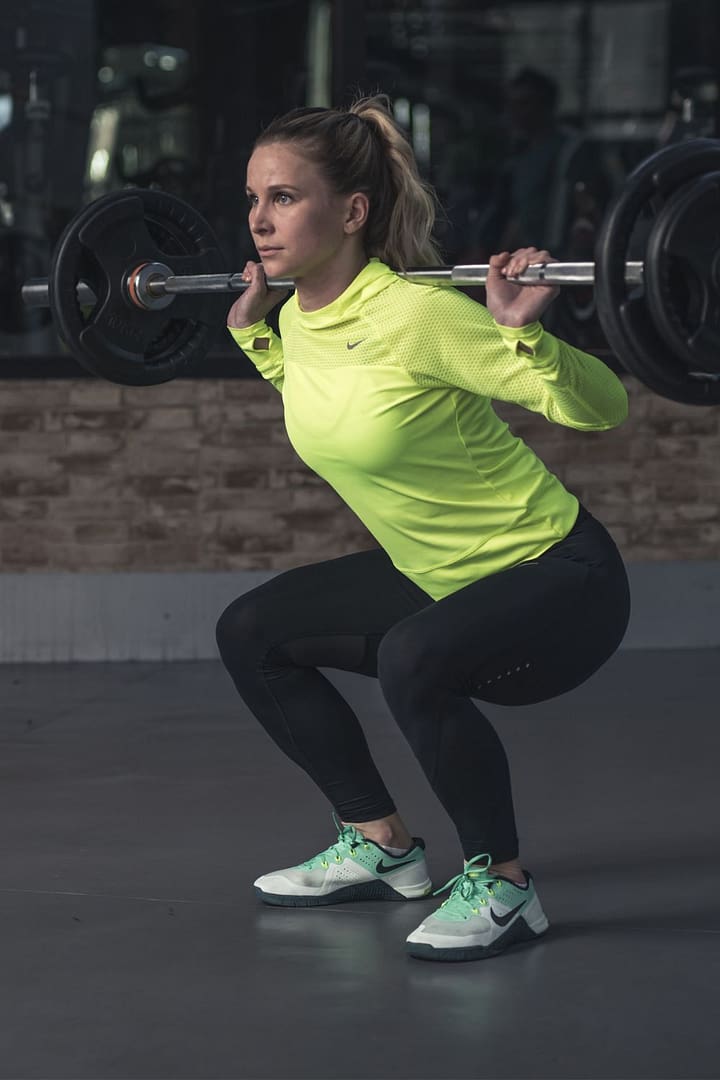 squat with barbell in the gym