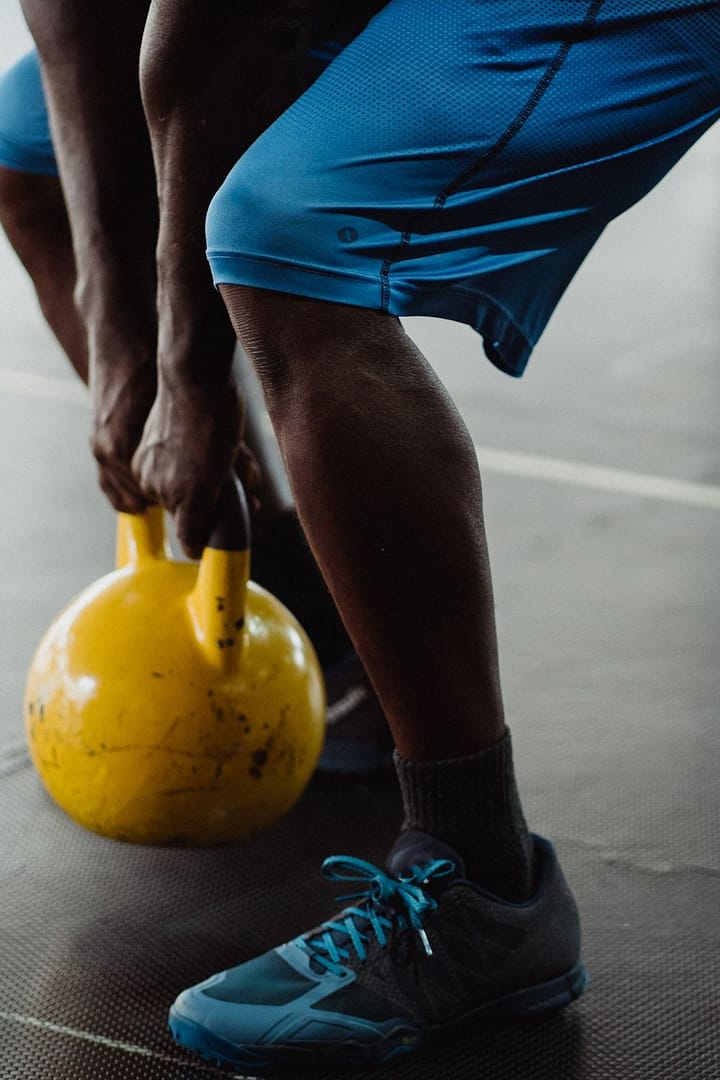 squatting with kettle weight