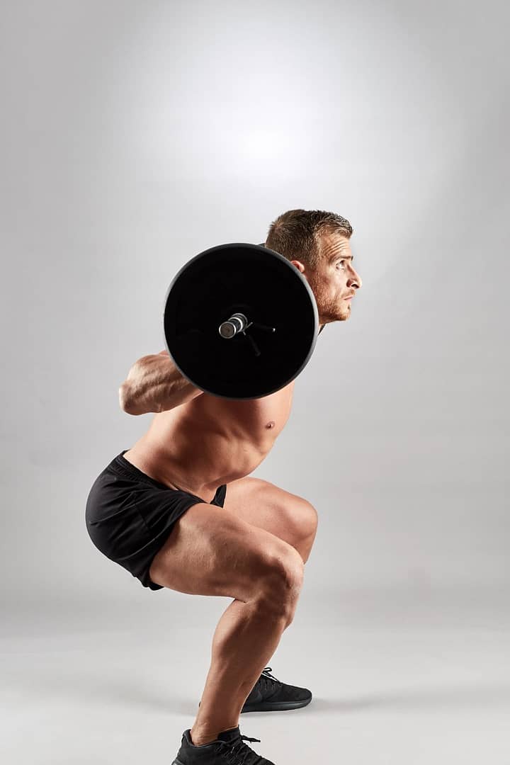 Man Doing Squats with Barbell ,,...