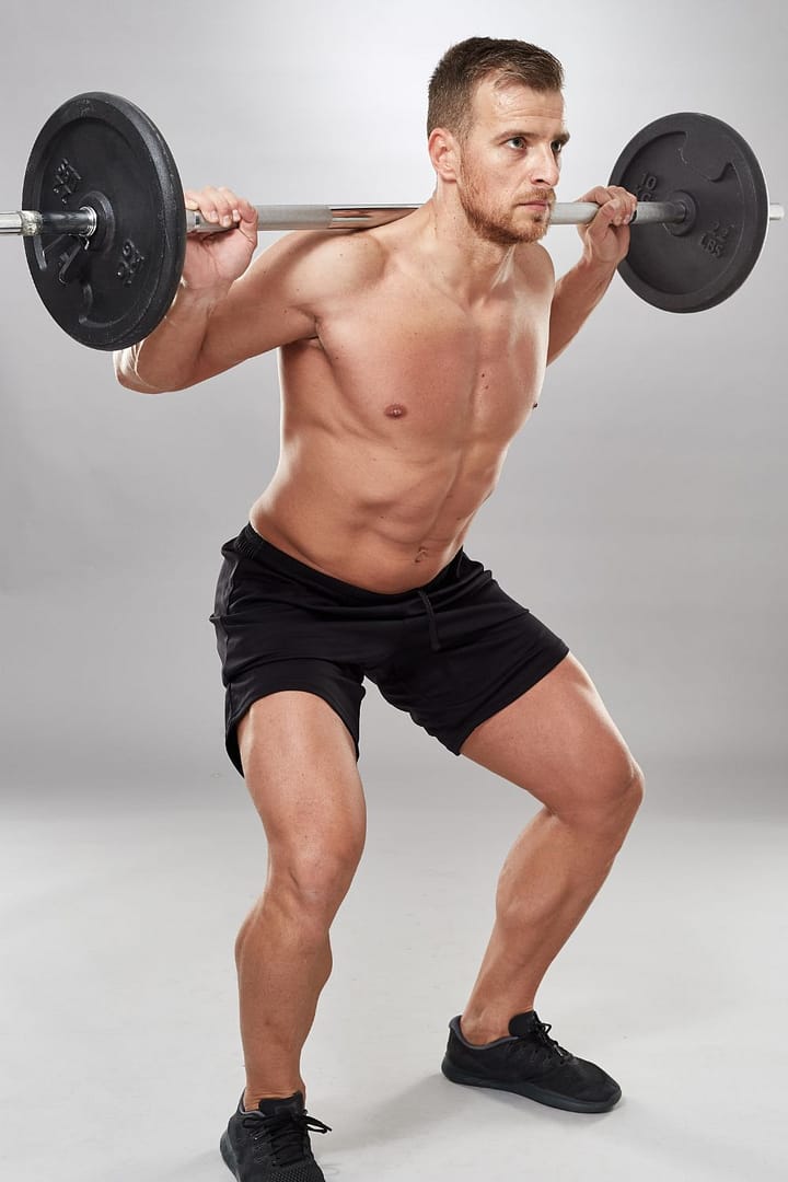 Man Doing Squats with Barbell