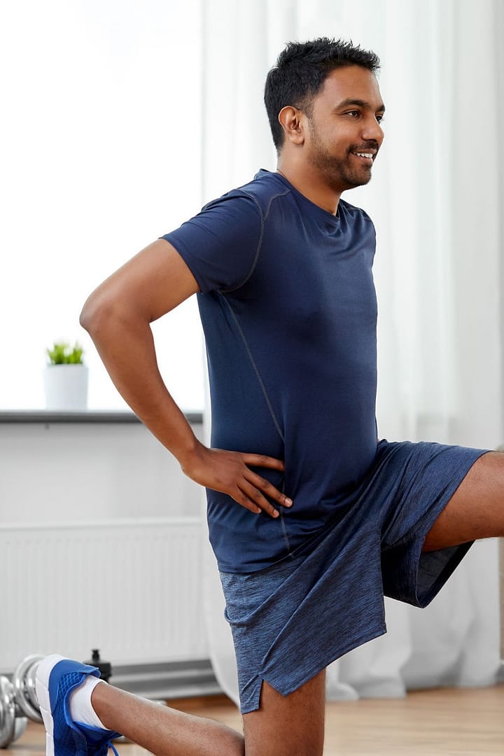 Man Exercising and Doing Lunges at Home