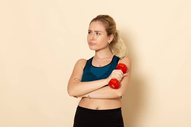front-view-young-female-sport-outfit-holding-red-dumbbells-white-wall-health-sport-body-beauty-workout.jpg