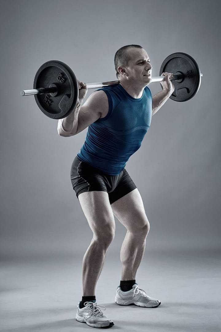 Man Doing Squats with Barbell .,